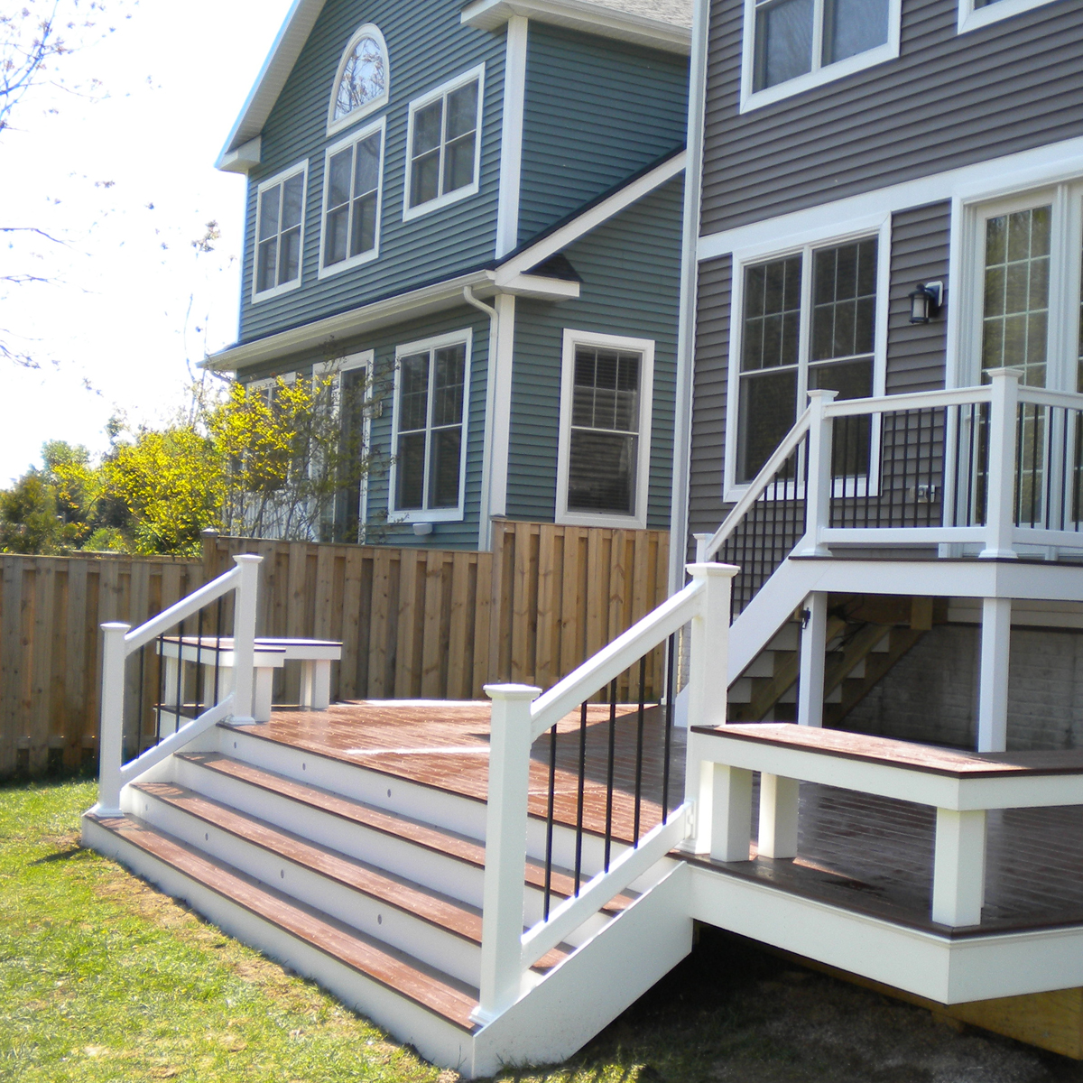 Rear deck that is directly at ground level. Showcases built in seating along the corners.