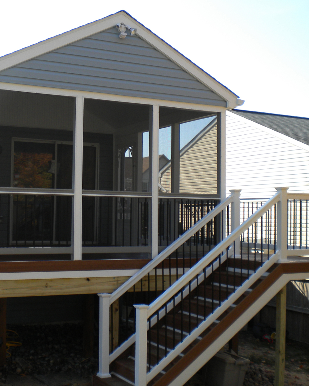 A fully inclosed sunroom on the rearside of the home. Screened in on all sides, with a staircase off the back.
