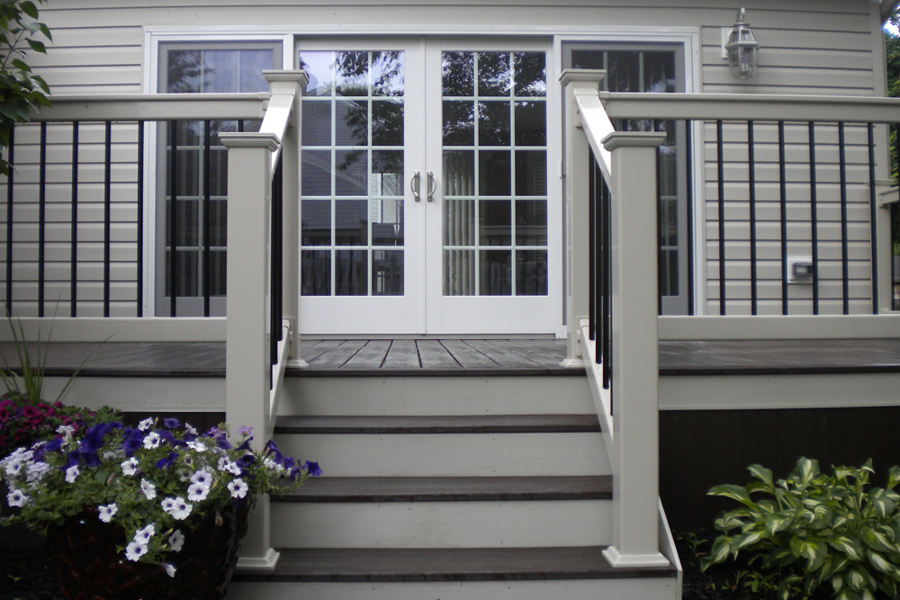 A rear back porch, that showcases a double wide glass door.